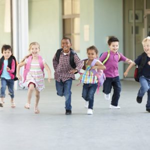 Group Of Elementary Age Schoolchildren Running Outside Group Of Elementary Age Schoolchildren Running Outside